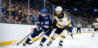 Tampa Bay Lightning vs. Boston Bruins TV Channel & Time (Apr 11) Tampa Bay Lightning's Nikita Kucherov (86) and Boston Bruins' David Pastrnak (88) battle for puck possession along the boards during an intense Atlantic Division NHL game.