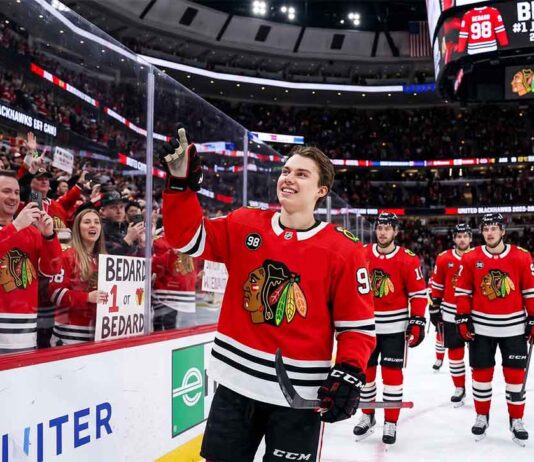 Connor Bedard celebrating on the ice with a sign stating "BEDARD #1 JERSEY SELLER," highlighting his position as the player with the top selling NHL jersey for the 2025-26 regular season.