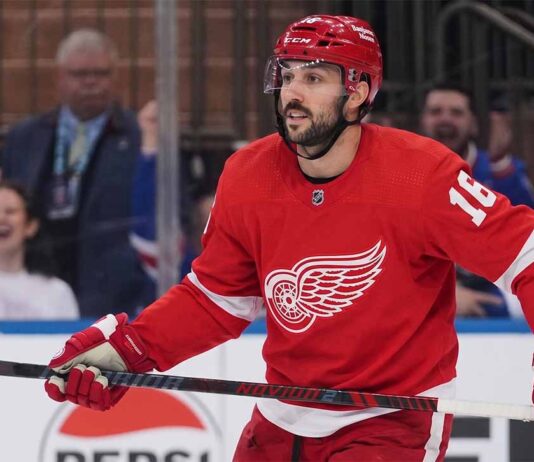 A conceptual image showing New York Rangers center Vincent Trocheck wearing a Detroit Red Wings home jersey #16 on the ice, illustrating NHL trade rumors.