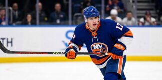 New York Islanders Interest in Simon Nemec | Devils Trade Rumors A photorealistic depiction of New Jersey Devils defenseman Šimon Nemec wearing a New York Islanders home uniform, illustrating trade rumors linking the player to the Islanders.