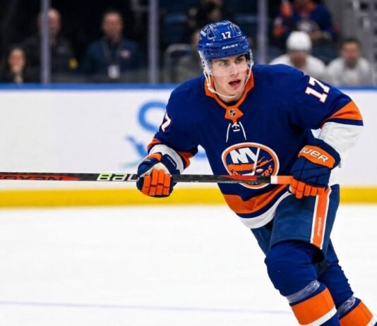 New York Islanders Interest in Simon Nemec | Devils Trade Rumors A photorealistic depiction of New Jersey Devils defenseman Šimon Nemec wearing a New York Islanders home uniform, illustrating trade rumors linking the player to the Islanders.