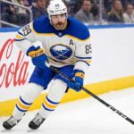 Buffalo Sabres forward Alex Tuch #89 in action skating with the puck, focal point of contract extension negotiations.