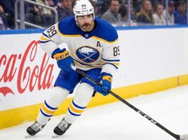 Alex Tuch Contract Rumors: Buffalo Sabres Salary Cap Impact Buffalo Sabres forward Alex Tuch #89 in action skating with the puck, focal point of contract extension negotiations.
