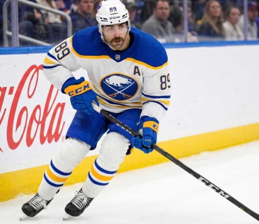 Buffalo Sabres forward Alex Tuch #89 in action skating with the puck, focal point of contract extension negotiations.