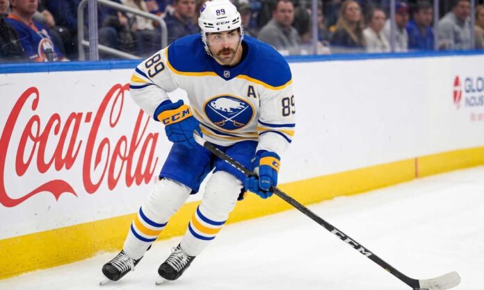 Buffalo Sabres forward Alex Tuch #89 in action skating with the puck, focal point of contract extension negotiations.