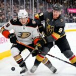 Cutter Gauthier of the Anaheim Ducks and Jack Eichel of the Vegas Golden Knights battle for the puck during Game 1 of their 2026 NHL Playoff series at T-Mobile Arena.