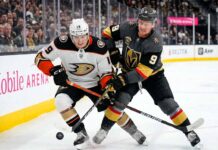 Cutter Gauthier of the Anaheim Ducks and Jack Eichel of the Vegas Golden Knights battle for the puck during Game 1 of their 2026 NHL Playoff series at T-Mobile Arena.
