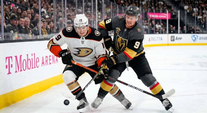 Cutter Gauthier of the Anaheim Ducks and Jack Eichel of the Vegas Golden Knights battle for the puck during Game 1 of their 2026 NHL Playoff series at T-Mobile Arena.