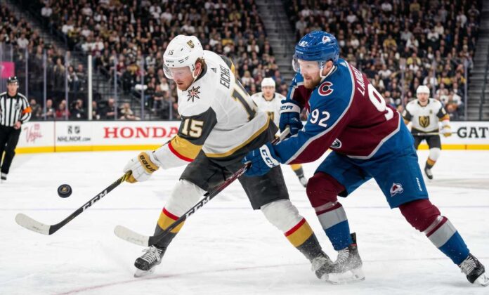 avalanche-vs-golden-knights-game-3-playoffs-2026 Jack Eichel (Vegas Golden Knights, #15) bats a puck out of the air while battling Gabriel Landeskog (Colorado Avalanche, #92) for possession during an intense sequence in the 2026 NHL Western Conference Final.