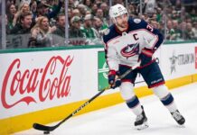 Will Boone Jenner Leave the Columbus Blue Jackets in Free Agency? Columbus Blue Jackets captain Boone Jenner (38) in a white away jersey looking focused on the ice while handling the puck.