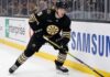 Boston Bruins Trade Rumors: Will Mason Lohrei Be Traded for a Top-Six Forward? Boston Bruins defenseman Mason Lohrei looks to advance the puck during a game. Lohrei, wearing jersey number 6, is the subject of recent NHL trade rumors suggesting he could be moved for a top-six forward.