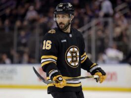 Conceptual photo of New York Rangers center Vincent Trocheck wearing a black Boston Bruins home jersey, number 16, holding a hockey stick on the ice.