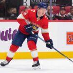 Florida Panthers Trade Rumors: Brady Tkachuk & Ottawa Senators A photo visualization of Ottawa Senators captain Brady Tkachuk wearing a Florida Panthers home jersey and number 7, used in an article discussing NHL trade rumors linking the forward to Florida.