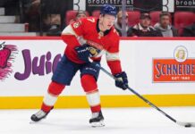 Florida Panthers Trade Rumors: Brady Tkachuk & Ottawa Senators A photo visualization of Ottawa Senators captain Brady Tkachuk wearing a Florida Panthers home jersey and number 7, used in an article discussing NHL trade rumors linking the forward to Florida.