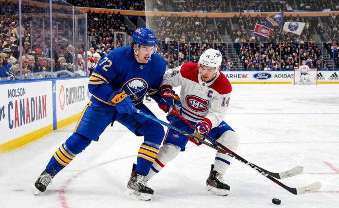 canadiens-vs-sabres-game-7-faceoff Tage Thompson #72 of the Buffalo Sabres and Nick Suzuki #14 of the Montreal Canadiens intensely battle for the puck on the ice during an NHL playoff game.