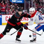NHL hockey game faceoff at Bell Centre: Carolina Hurricanes forward Taylor Hall #71 and Montreal Canadiens defenseman Lane Hutson #48 prepare for puck drop during the NHL playoffs.