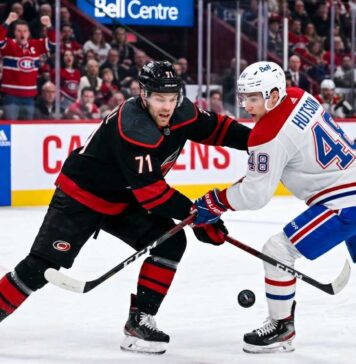 NHL hockey game faceoff at Bell Centre: Carolina Hurricanes forward Taylor Hall #71 and Montreal Canadiens defenseman Lane Hutson #48 prepare for puck drop during the NHL playoffs.