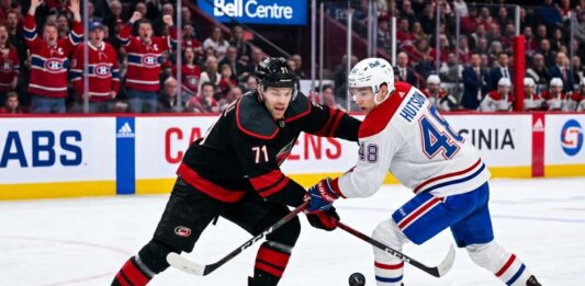 NHL hockey game faceoff at Bell Centre: Carolina Hurricanes forward Taylor Hall #71 and Montreal Canadiens defenseman Lane Hutson #48 prepare for puck drop during the NHL playoffs.