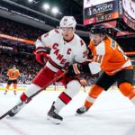 Sebastian Aho (Carolina Hurricanes, #20) controls the puck against Travis Konecny (Philadelphia Flyers, #11) during Game 3 of the 2026 NHL Eastern Conference Semi-Finals at Xfinity Mobile Arena.