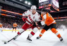 Sebastian Aho (Carolina Hurricanes, #20) controls the puck against Travis Konecny (Philadelphia Flyers, #11) during Game 3 of the 2026 NHL Eastern Conference Semi-Finals at Xfinity Mobile Arena.
