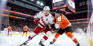 Sebastian Aho (Carolina Hurricanes, #20) controls the puck against Travis Konecny (Philadelphia Flyers, #11) during Game 3 of the 2026 NHL Eastern Conference Semi-Finals at Xfinity Mobile Arena.
