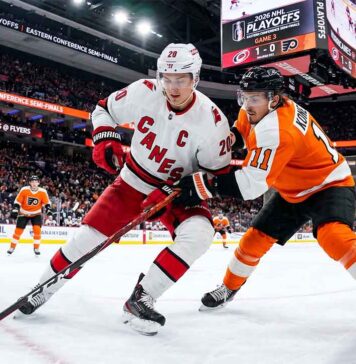 Sebastian Aho (Carolina Hurricanes, #20) controls the puck against Travis Konecny (Philadelphia Flyers, #11) during Game 3 of the 2026 NHL Eastern Conference Semi-Finals at Xfinity Mobile Arena.