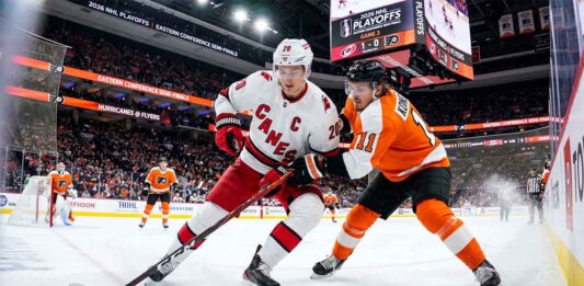 Sebastian Aho (Carolina Hurricanes, #20) controls the puck against Travis Konecny (Philadelphia Flyers, #11) during Game 3 of the 2026 NHL Eastern Conference Semi-Finals at Xfinity Mobile Arena.