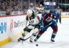Minnesota Wild star Kirill Kaprizov (#97) engages in an intense board battle for the puck with Colorado Avalanche captain Nathan MacKinnon (#29) during Game 4 of their NHL playoff series at Xcel Energy Center on Monday, May 11, 2026.