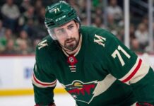 Minnesota Wild Trade Rumors: Detroit Red Wings Center Dylan Larkin Close-up photo of Detroit Red Wings center and captain Dylan Larkin, wearing jersey #71 in a Minnesota Wild uniform, who is the subject of Minnesota Wild NHL trade rumors to fill their top-line center role.