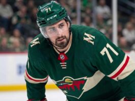 Minnesota Wild Trade Rumors: Detroit Red Wings Center Dylan Larkin Close-up photo of Detroit Red Wings center and captain Dylan Larkin, wearing jersey #71 in a Minnesota Wild uniform, who is the subject of Minnesota Wild NHL trade rumors to fill their top-line center role.