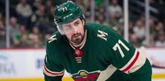 Close-up photo of Detroit Red Wings center and captain Dylan Larkin, wearing jersey #71 in a Minnesota Wild uniform, who is the subject of Minnesota Wild NHL trade rumors to fill their top-line center role.