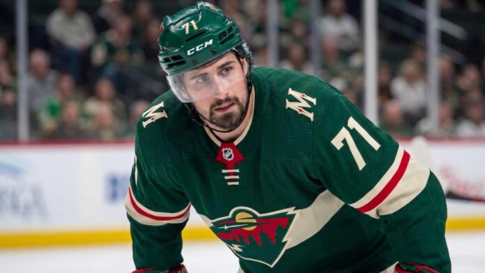 dylan-larkin-detroit-red-wings-minnesota-wild-trade Close-up photo of Detroit Red Wings center and captain Dylan Larkin, wearing jersey #71 in a Minnesota Wild uniform, who is the subject of Minnesota Wild NHL trade rumors to fill their top-line center role.