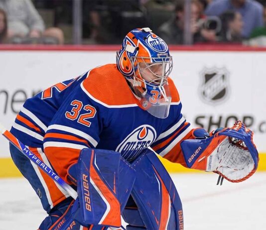 A conceptual photograph visualizing goaltender Filip Gustavsson wearing a royal blue and orange Edmonton Oilers uniform with number 32, representing the rumored NHL trade from the Minnesota Wild.