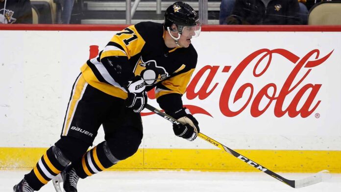 Pittsburgh Penguins center Evgeni Malkin (#71) in black and gold jersey, skating with his hockey stick along the arena boards featuring a prominent Coca-Cola advertisement.