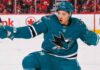 An image of Jason Robertson, wearing a teal San Jose Sharks jersey with number 71, celebrating a goal on the ice. This photo visually depicts the blockbuster trade rumor scenario.