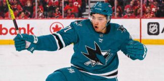 An image of Jason Robertson, wearing a teal San Jose Sharks jersey with number 71, celebrating a goal on the ice. This photo visually depicts the blockbuster trade rumor scenario.