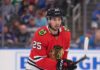 Chicago Blackhawks Trade Rumors: Will They Acquire Jordan Kyrou? NHL player Jordan Kyrou wearing a Chicago Blackhawks red jersey and helmet on the ice, visualizing trade rumors connecting him to Chicago.