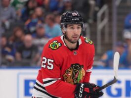 Chicago Blackhawks Trade Rumors: Will They Acquire Jordan Kyrou? NHL player Jordan Kyrou wearing a Chicago Blackhawks red jersey and helmet on the ice, visualizing trade rumors connecting him to Chicago.