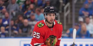 Chicago Blackhawks Trade Rumors: Will They Acquire Jordan Kyrou? NHL player Jordan Kyrou wearing a Chicago Blackhawks red jersey and helmet on the ice, visualizing trade rumors connecting him to Chicago.