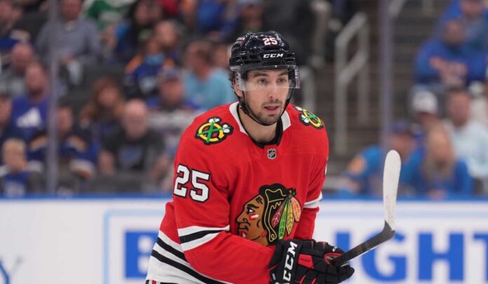 NHL player Jordan Kyrou wearing a Chicago Blackhawks red jersey and helmet on the ice, visualizing trade rumors connecting him to Chicago.