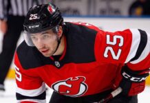 A visualization of trade rumors: St. Louis Blues forward Jordan Kyrou pictured in a New Jersey Devils jersey, skating at the Prudential Center.