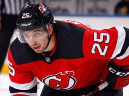 A visualization of trade rumors: St. Louis Blues forward Jordan Kyrou pictured in a New Jersey Devils jersey, skating at the Prudential Center.