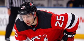 A visualization of trade rumors: St. Louis Blues forward Jordan Kyrou pictured in a New Jersey Devils jersey, skating at the Prudential Center.