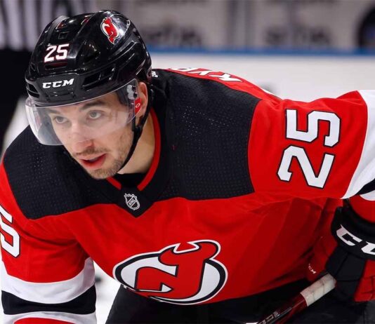A visualization of trade rumors: St. Louis Blues forward Jordan Kyrou pictured in a New Jersey Devils jersey, skating at the Prudential Center.