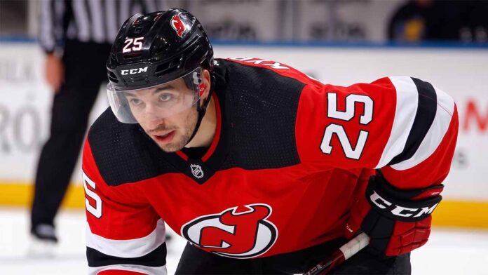 jordan-kyrou-st-louis-blues-devils-trade-rumor A visualization of trade rumors: St. Louis Blues forward Jordan Kyrou pictured in a New Jersey Devils jersey, skating at the Prudential Center.