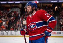 Montreal Canadiens Trade Rumors: Mason McTavish from Anaheim Ducks? Anaheim Ducks center Mason McTavish on the ice wearing a Montreal Canadiens home jersey, fueling trade rumors about him becoming the Habs' new second-line center.