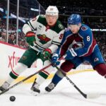 Cale Makar of the Colorado Avalanche and Kirill Kaprizov of the Minnesota Wild battle for the puck during Game 2 of their 2026 NHL playoff series.