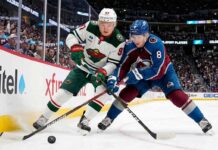 Cale Makar of the Colorado Avalanche and Kirill Kaprizov of the Minnesota Wild battle for the puck during Game 2 of their 2026 NHL playoff series.