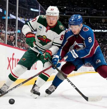 Cale Makar of the Colorado Avalanche and Kirill Kaprizov of the Minnesota Wild battle for the puck during Game 2 of their 2026 NHL playoff series.