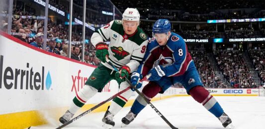 Cale Makar of the Colorado Avalanche and Kirill Kaprizov of the Minnesota Wild battle for the puck during Game 2 of their 2026 NHL playoff series.
